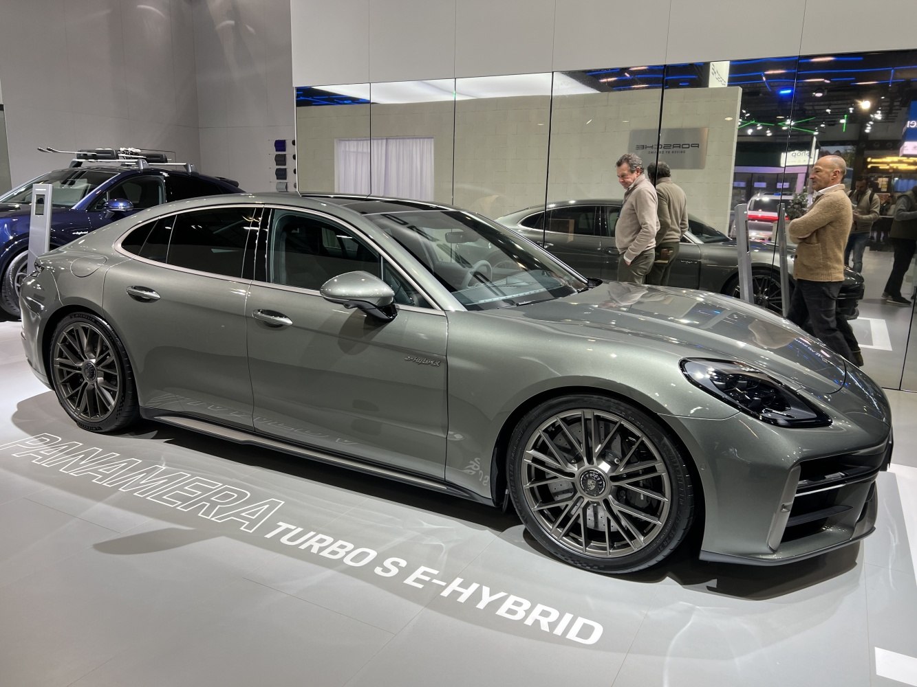 Side profile of luxury hybrid sedan with detailed alloy wheels