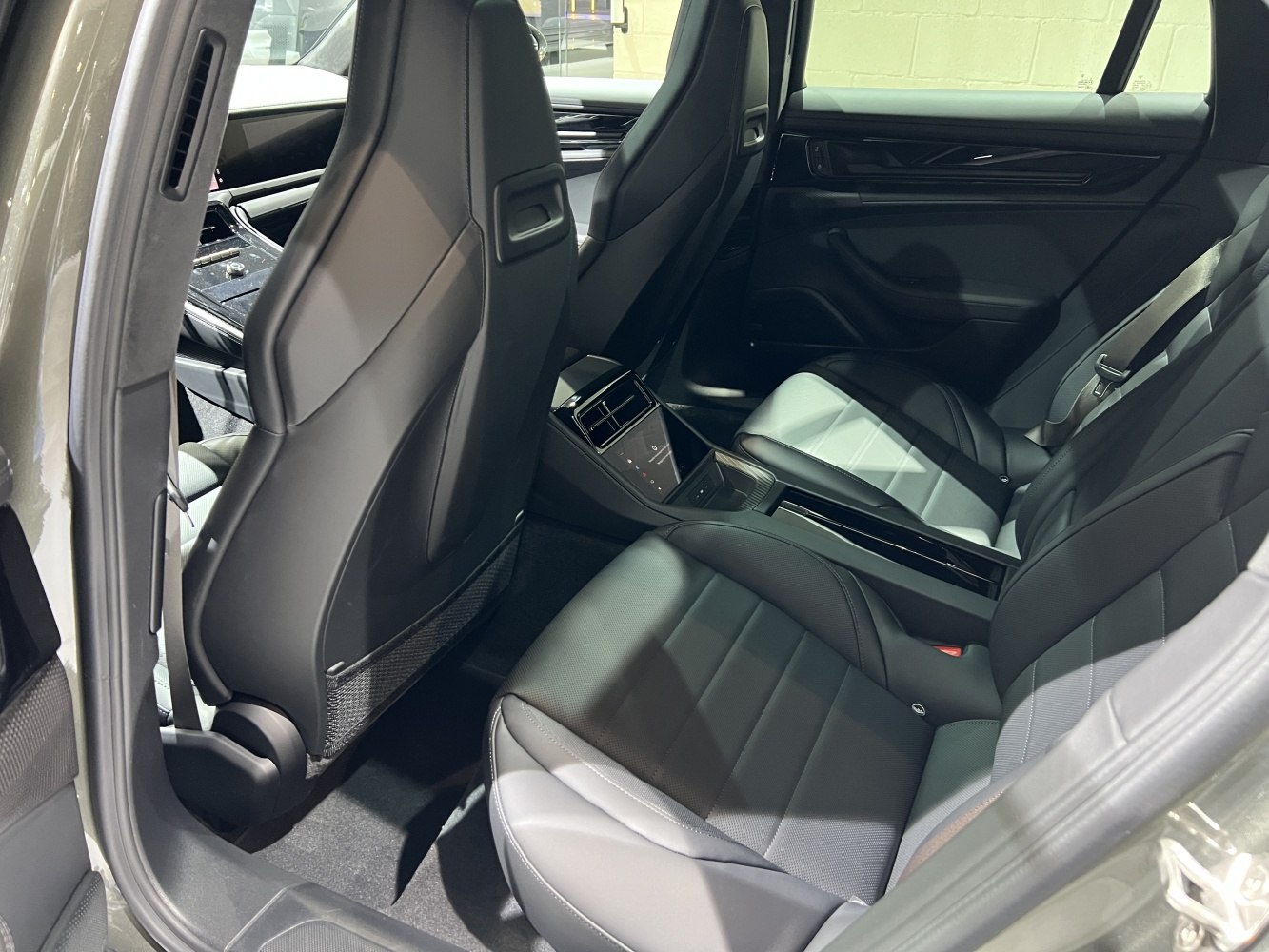 Premium rear seating with black leather upholstery and modern cabin design