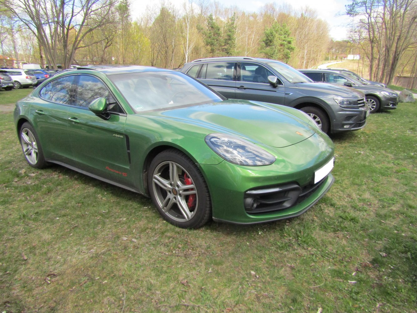 Green sports sedan with aerodynamic headlights and alloy wheels