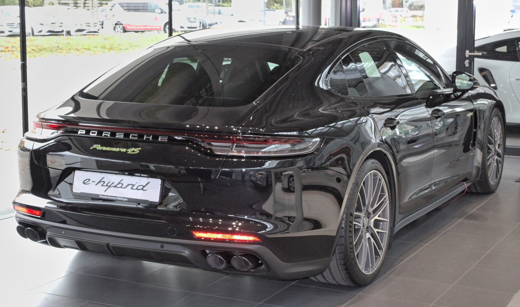 Rear view of e-Hybrid sedan with distinctive taillights and quad exhausts