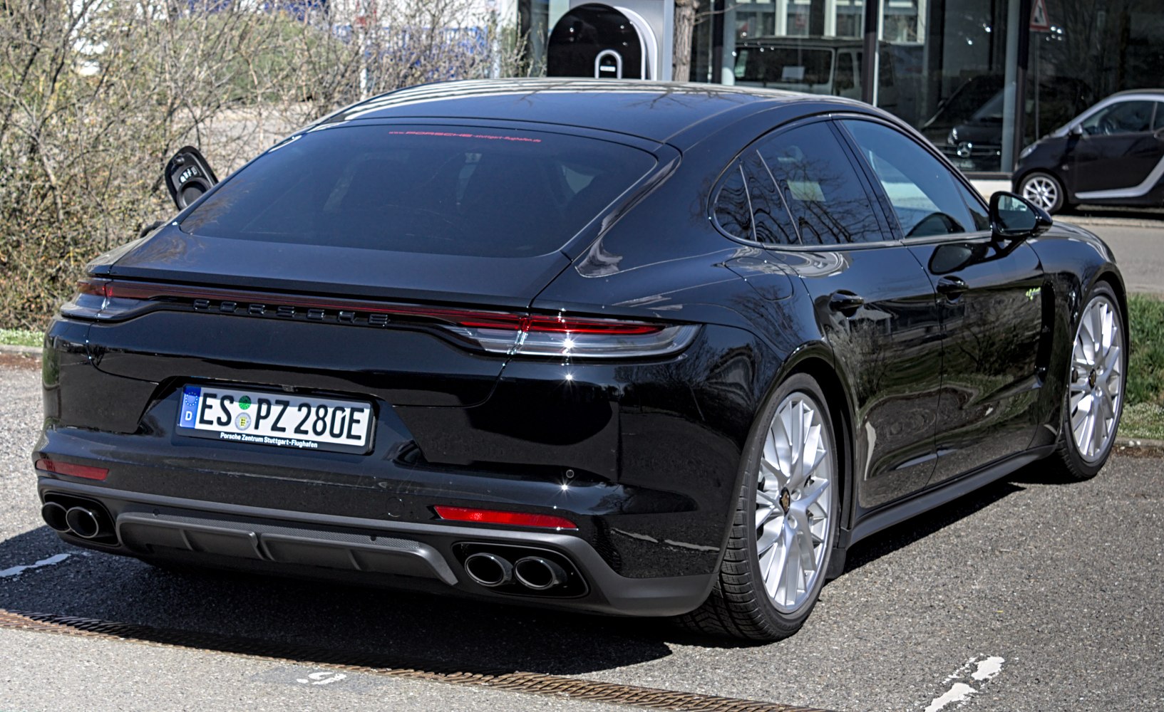Sleek rear view with quad exhaust and continuous tail light bar