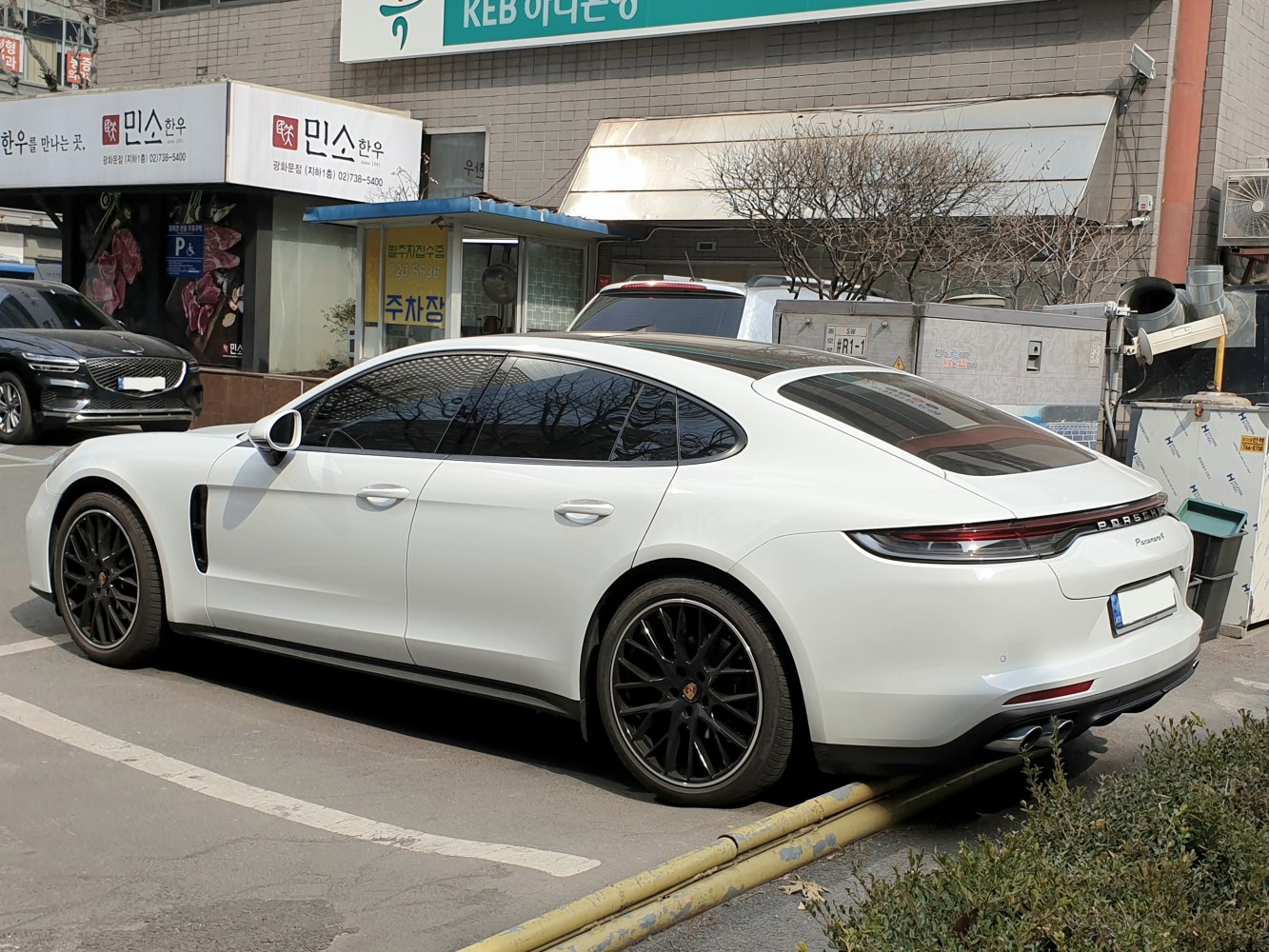Elegant rear and side profile with black alloy wheels and tinted windows