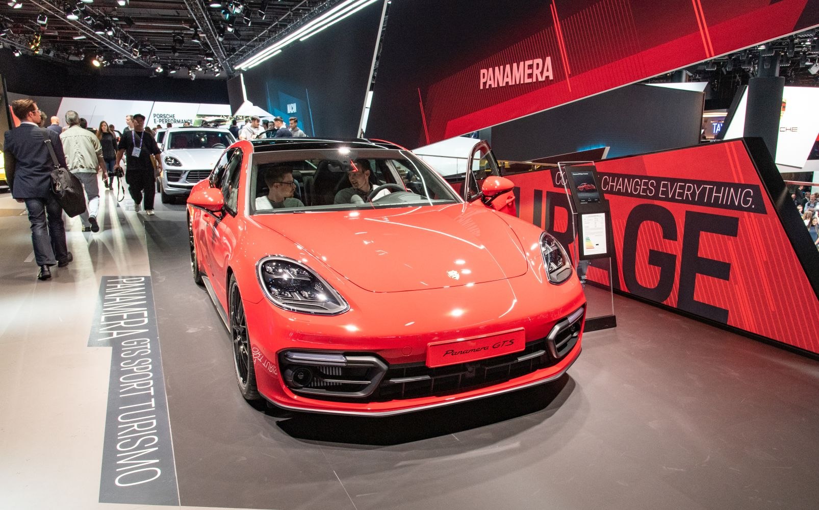 Front view and interior seating of a red sports wagon with panoramic roof.