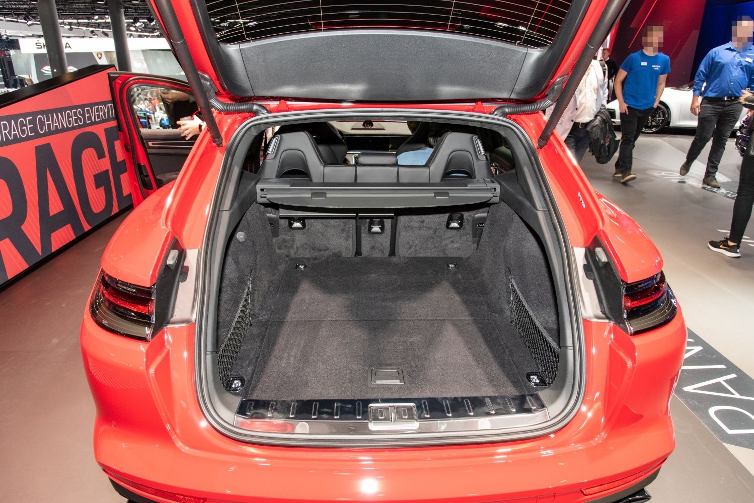 Spacious rear cargo area with an open hatch and black upholstery