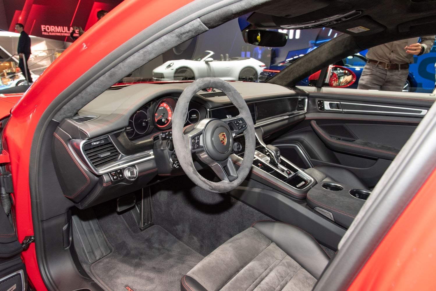 Luxury interior with sporty steering wheel and advanced dashboard.