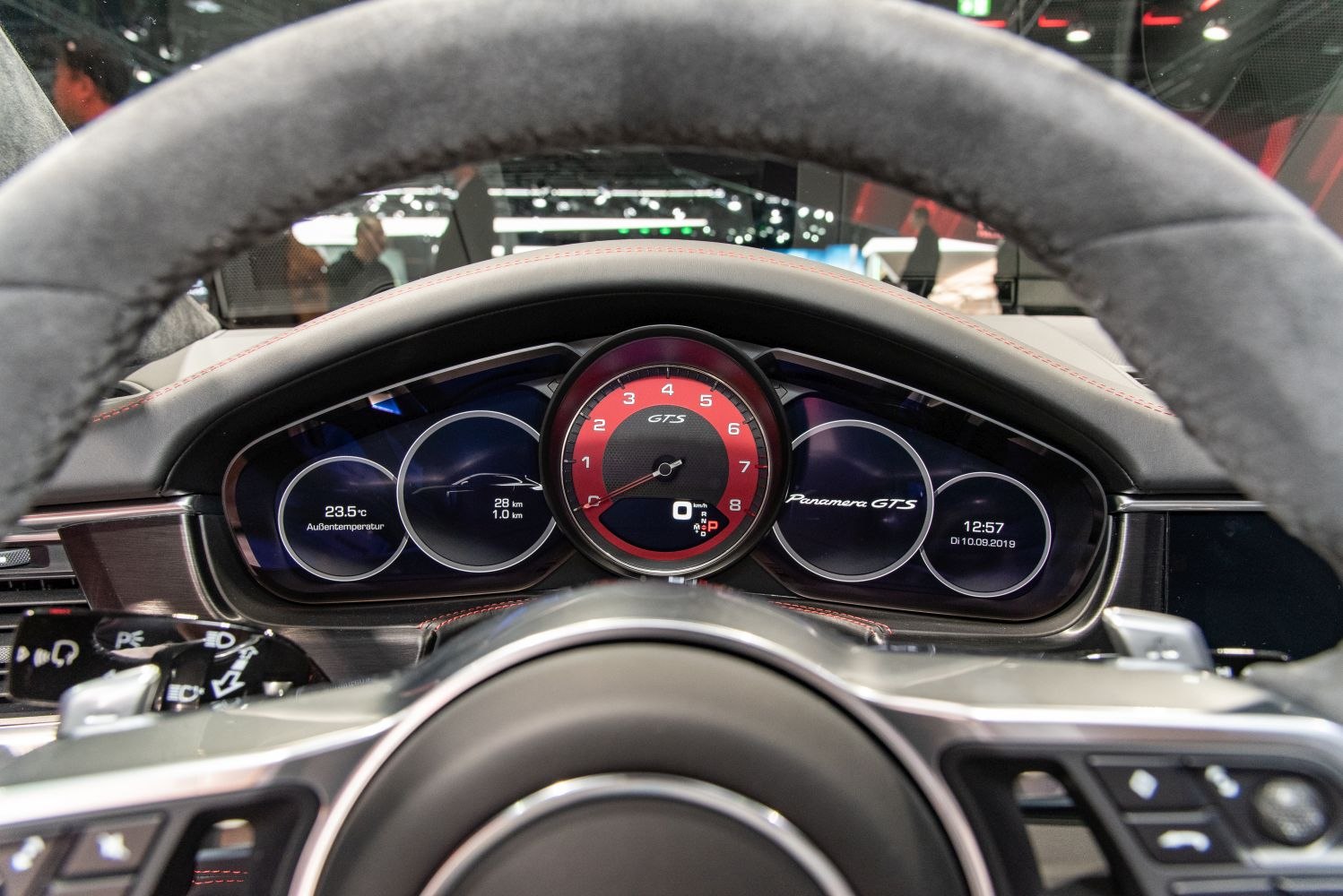 Red central tachometer and modern digital dashboard with multiple driver displays