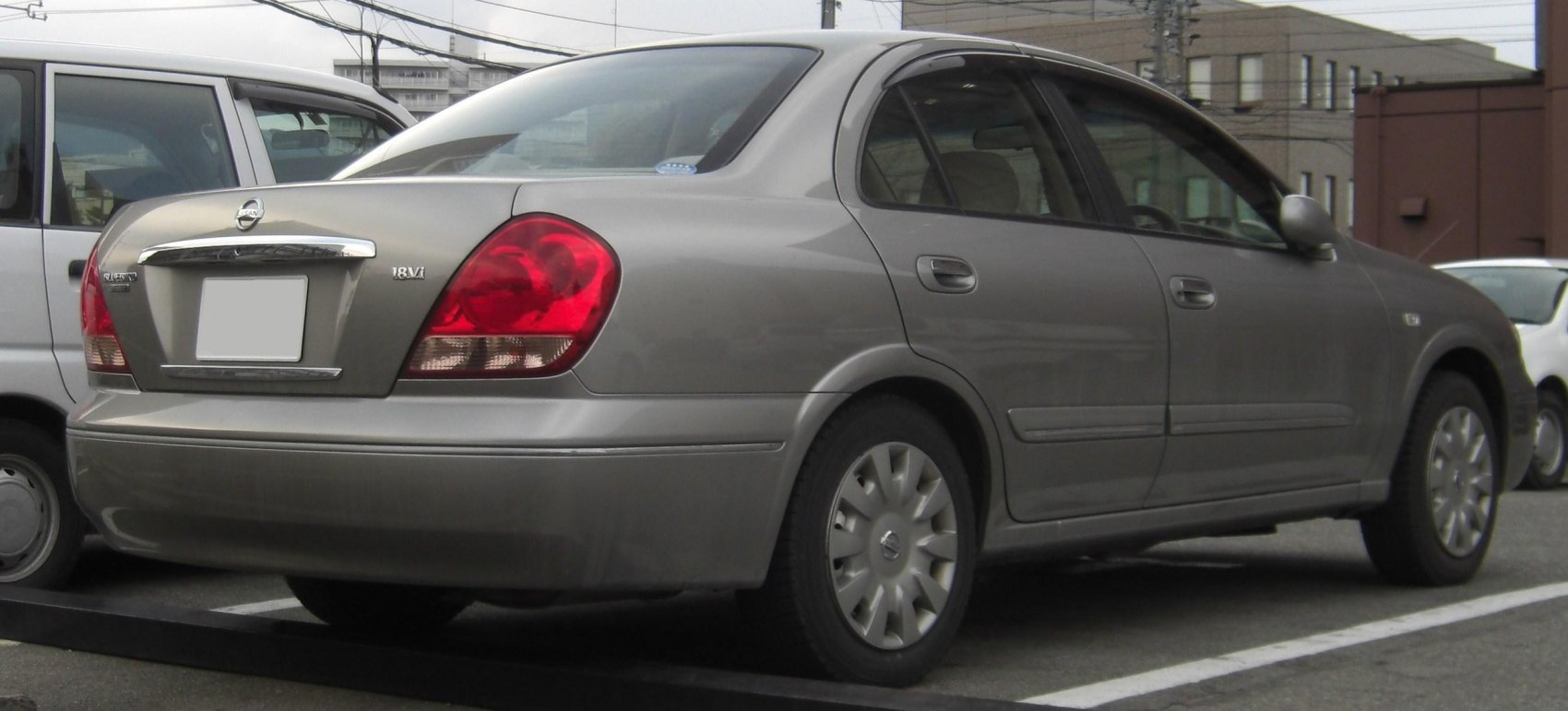 Rear and side view of a sedan with distinctive tail lights and four-door design