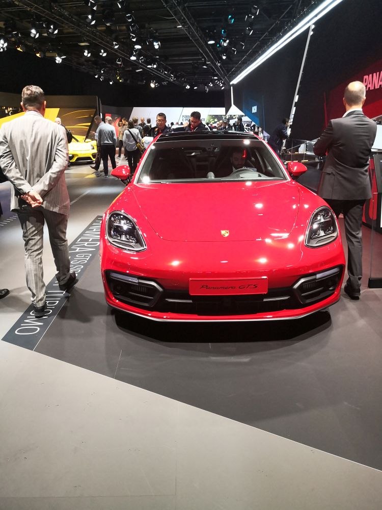 Red luxury sport sedan with LED headlights, sleek front design.