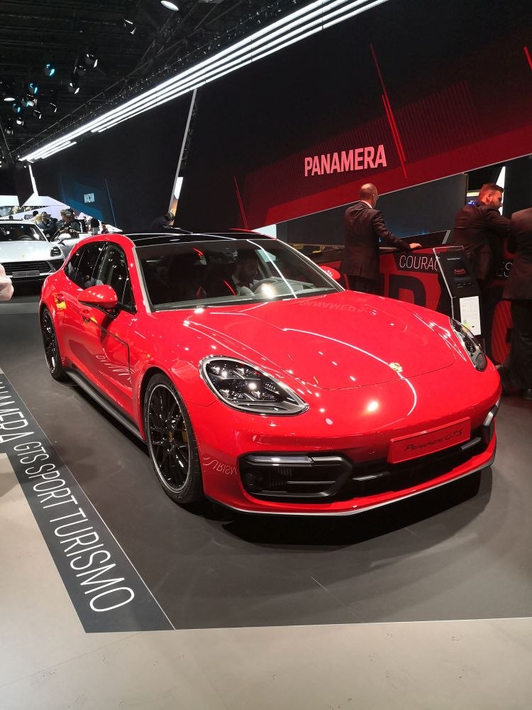 Red sporty sedan with black roof and LED headlights