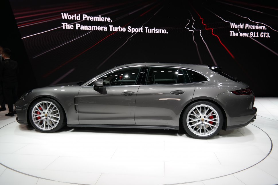 Side profile of a sleek estate with sporty alloy wheels and smooth design.