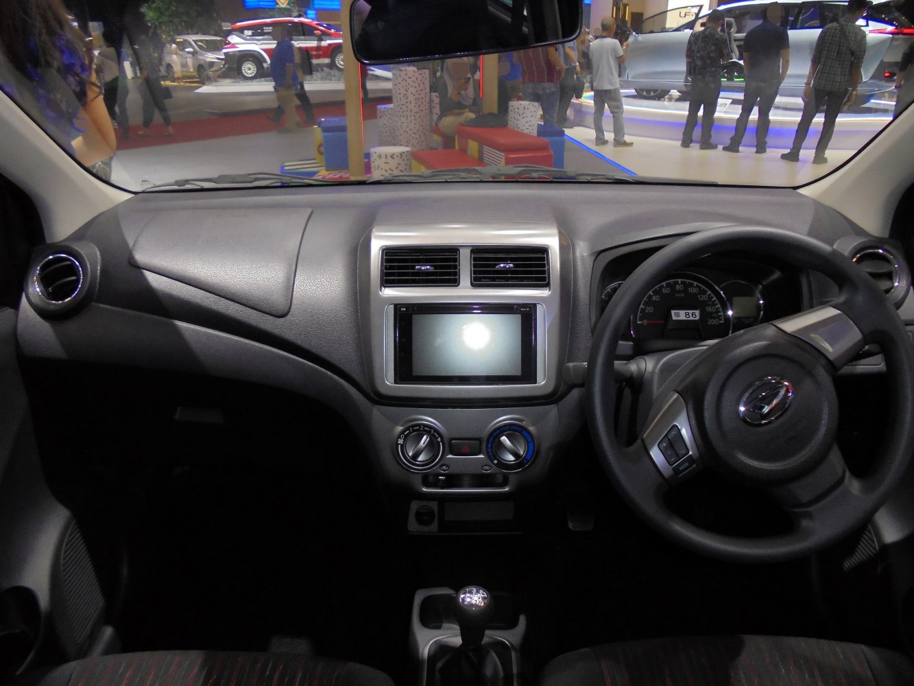 Dashboard with manual gear stick and steering wheel, centered climate controls