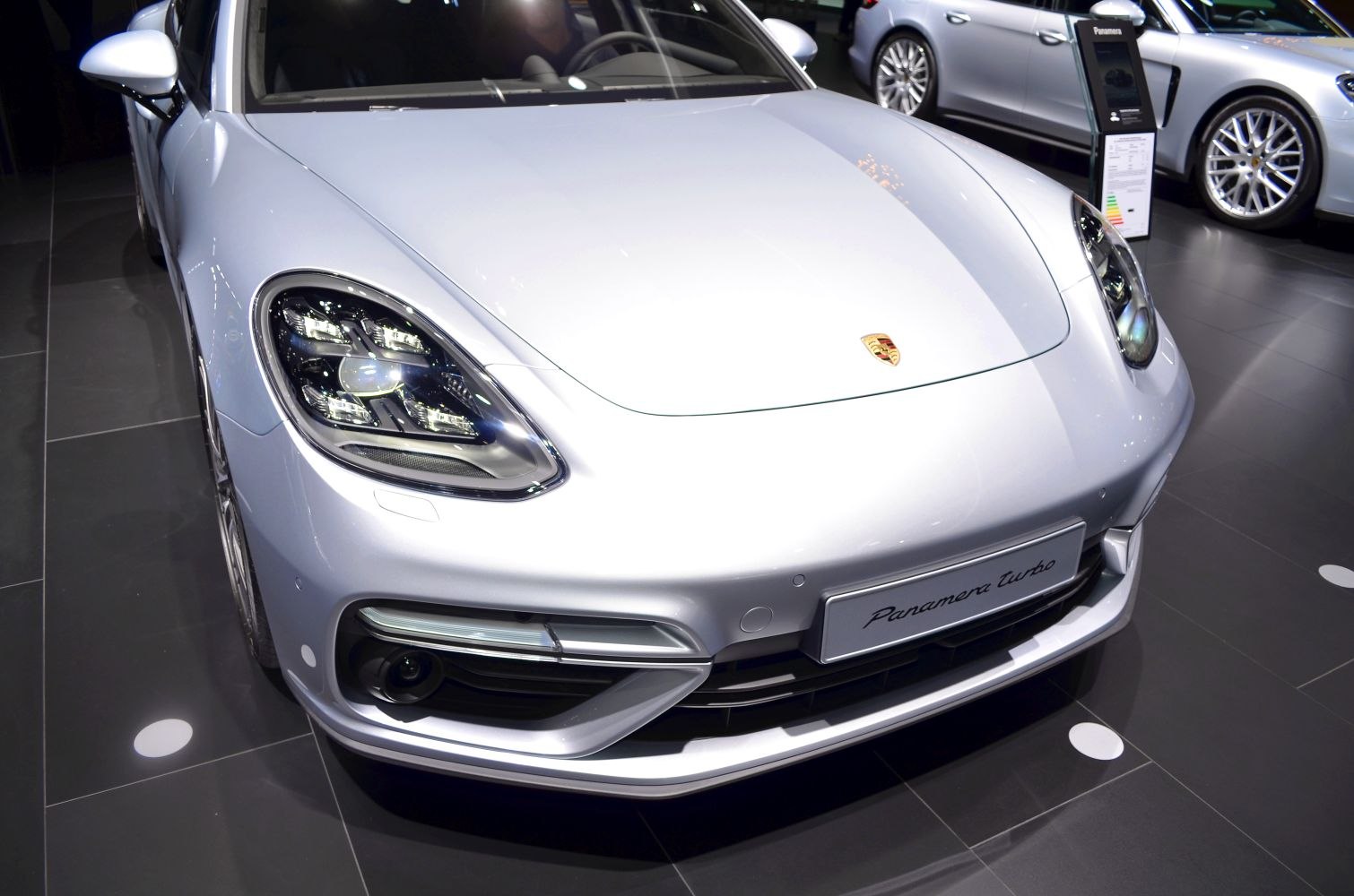 Sleek hood and advanced LED headlights of a luxury sedan.