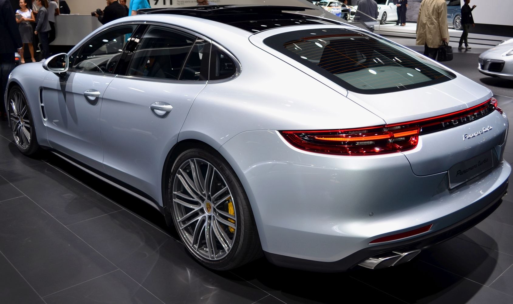 Rear side view of a luxury sedan with sleek connected taillights and sporty alloy wheels