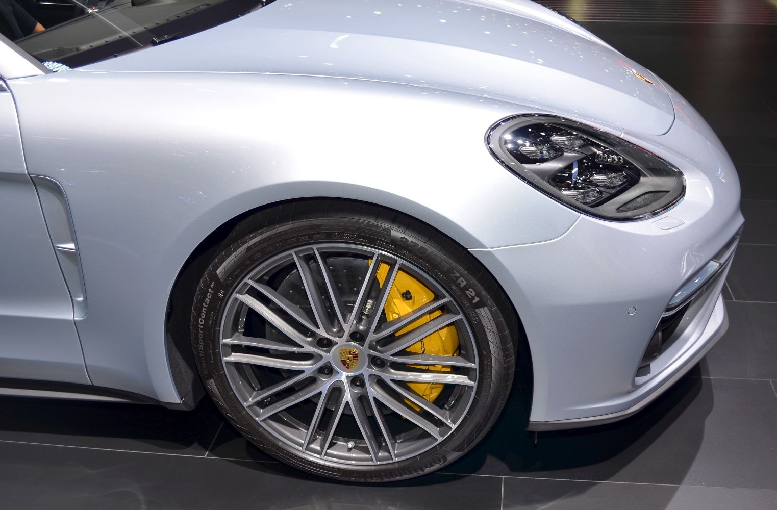 Front wheel with yellow brake calipers and modern headlight