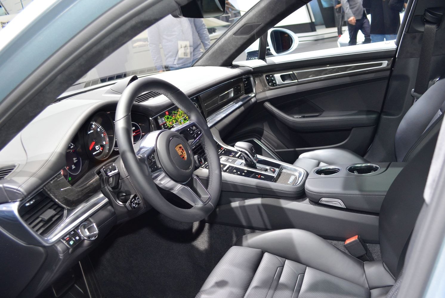 Modern luxury car cockpit with steering wheel and digital dashboard