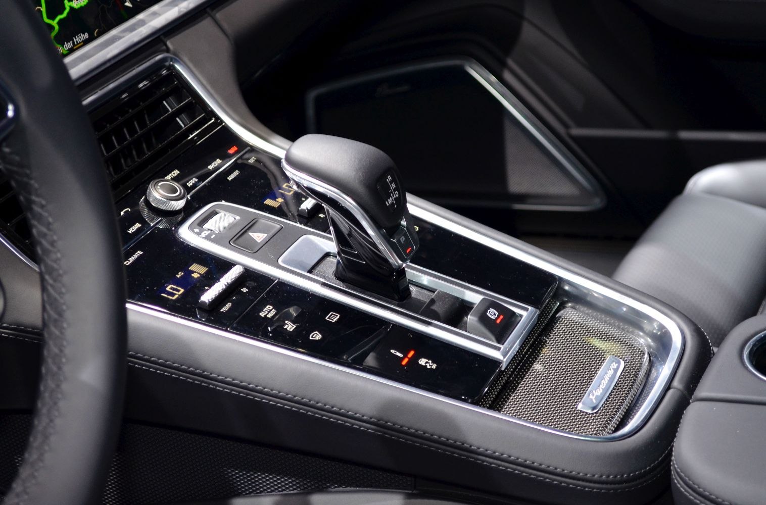 Close-up of gear shifter and center console controls in luxury car interior
