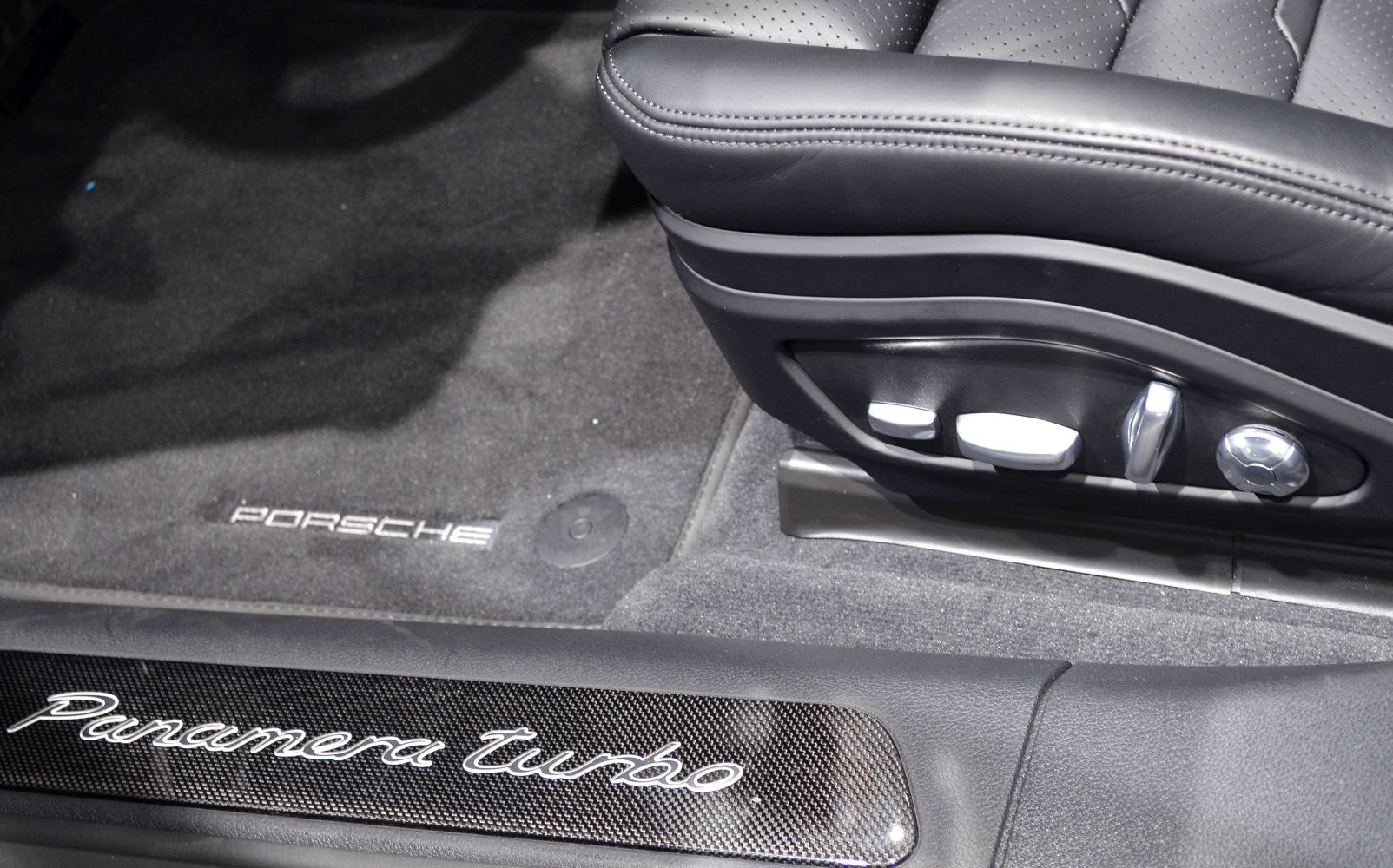 Seat adjustment controls and carbon fiber door sill plate