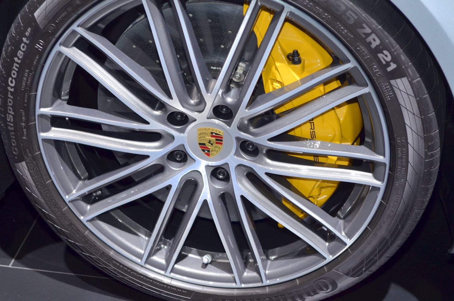 Multi-spoke alloy wheel with yellow brake caliper