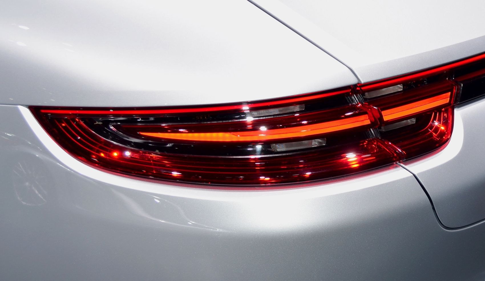 Close-up of rear LED taillight with sleek red illumination.