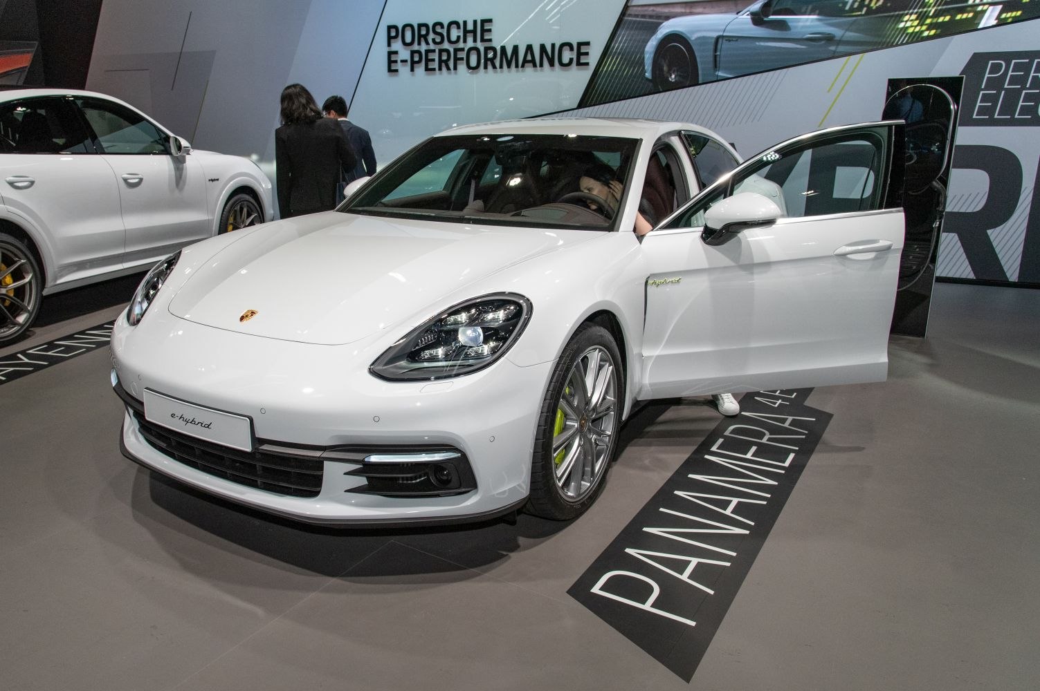 White luxury sedan with open door and LED headlights