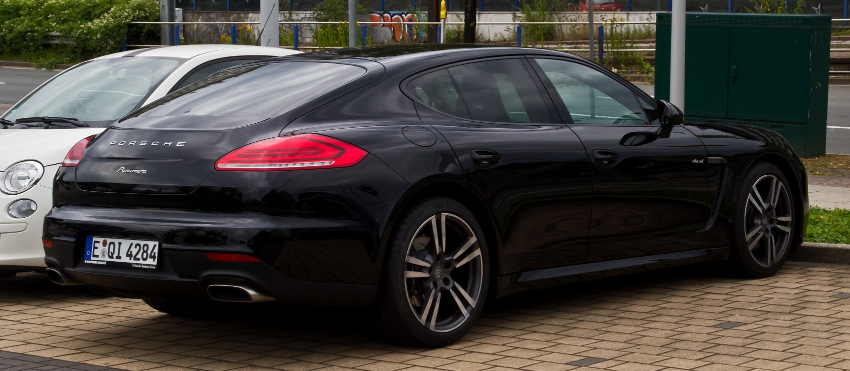 Rear 3/4 view of black luxury sports sedan with sleek design and modern taillights