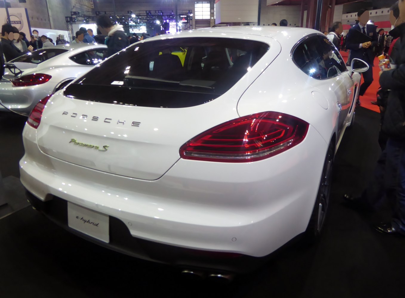 White luxury sedan rear with distinctive taillights and e-hybrid badge