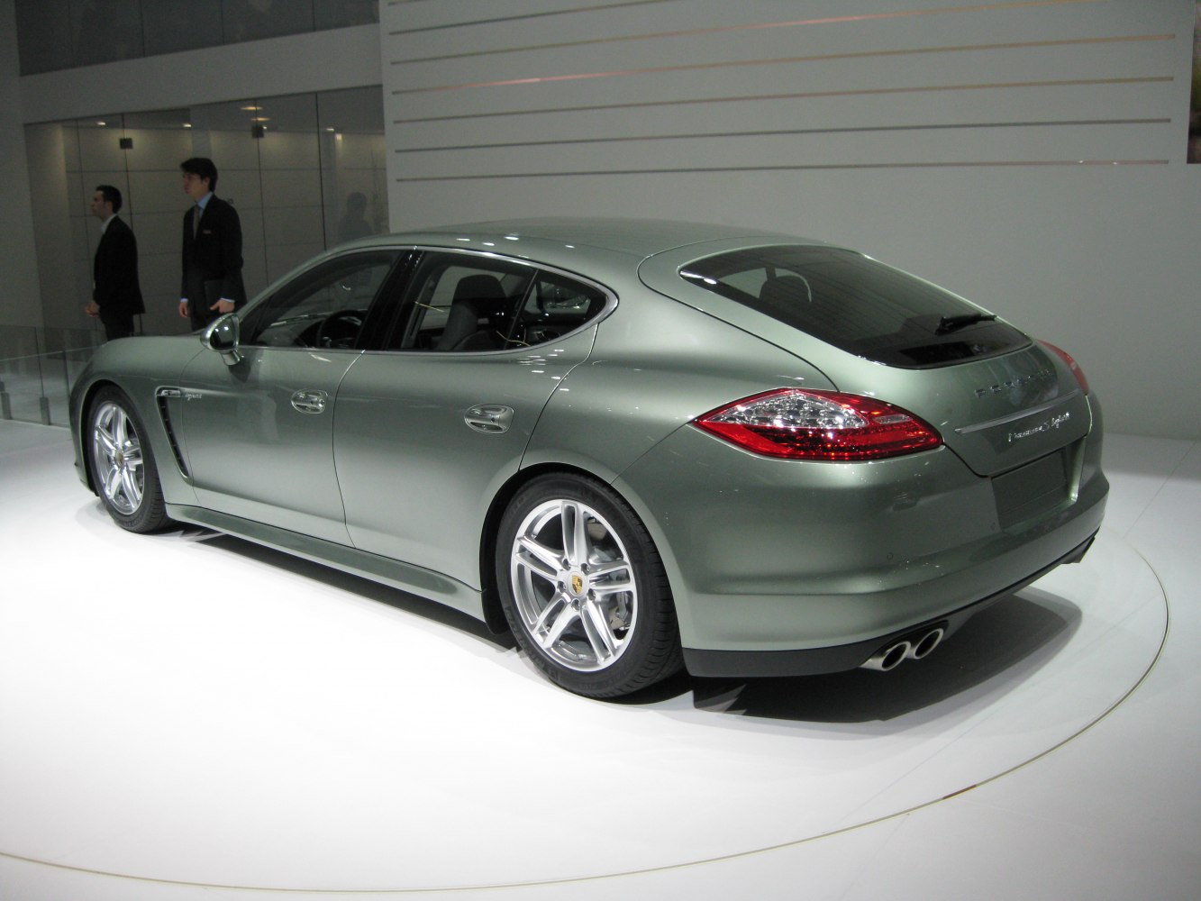Rear and side view of a silver sports sedan with dual exhaust and distinctive tail lights