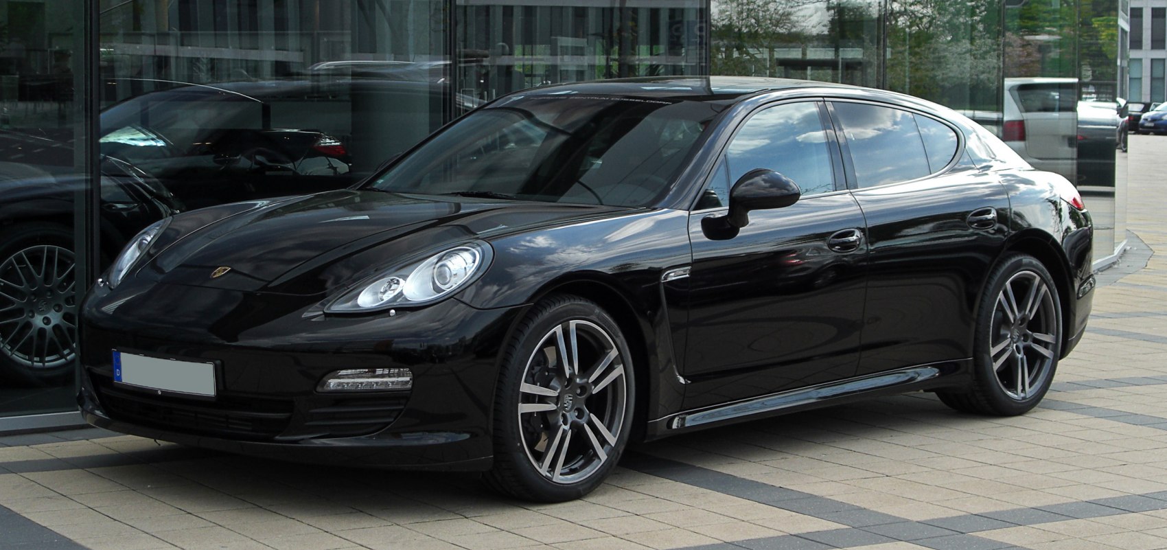 Black luxury sedan with sporty multi-spoke alloy wheels and aerodynamic front