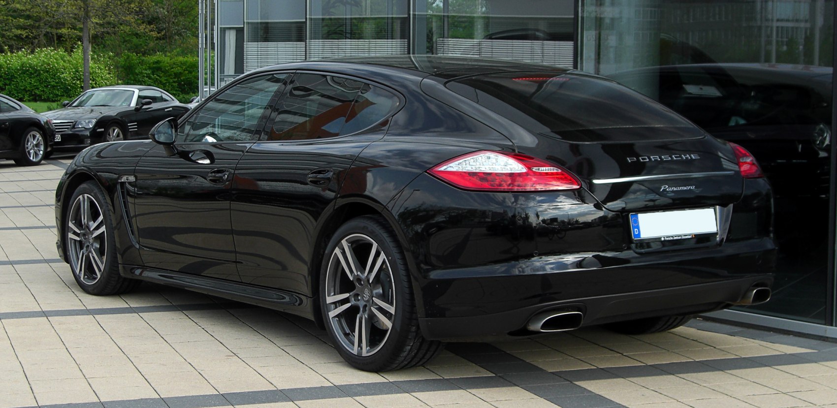 Rear view of a luxury sedan with sleek tail lights and dual exhaust