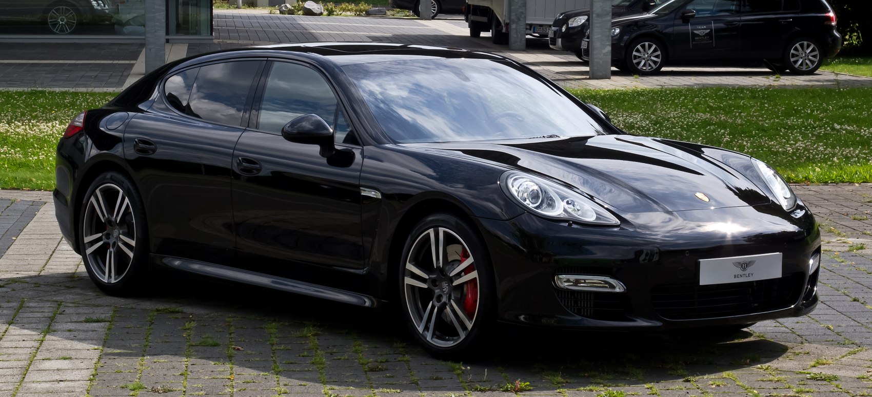 Black luxury sedan with sporty design and alloy wheels.
