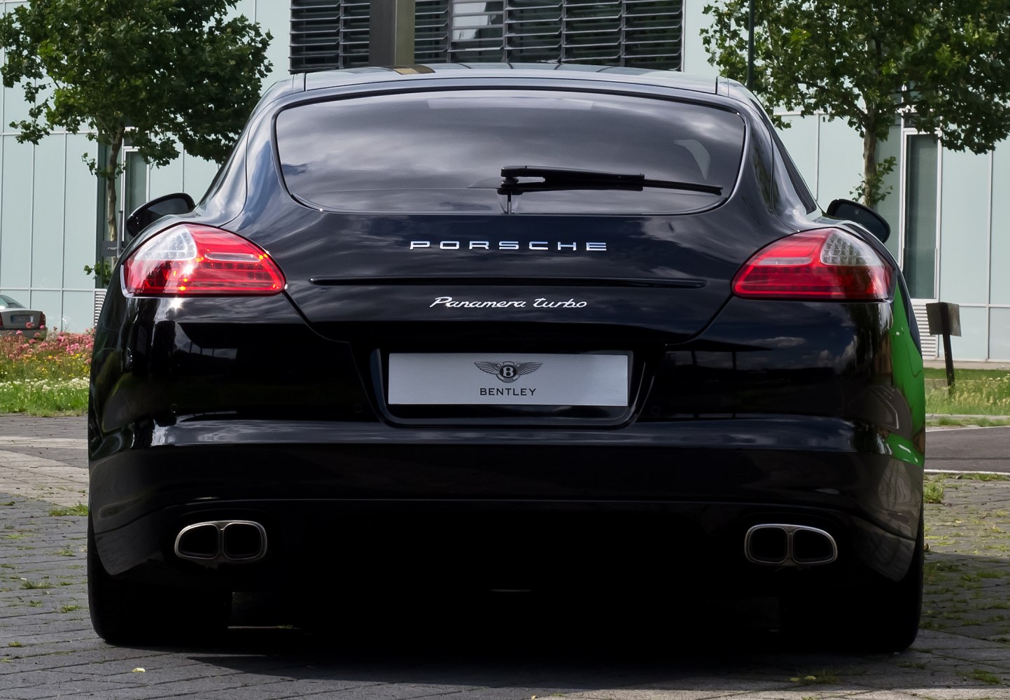 Rear hatchback view with dual exhaust and signature tail lights