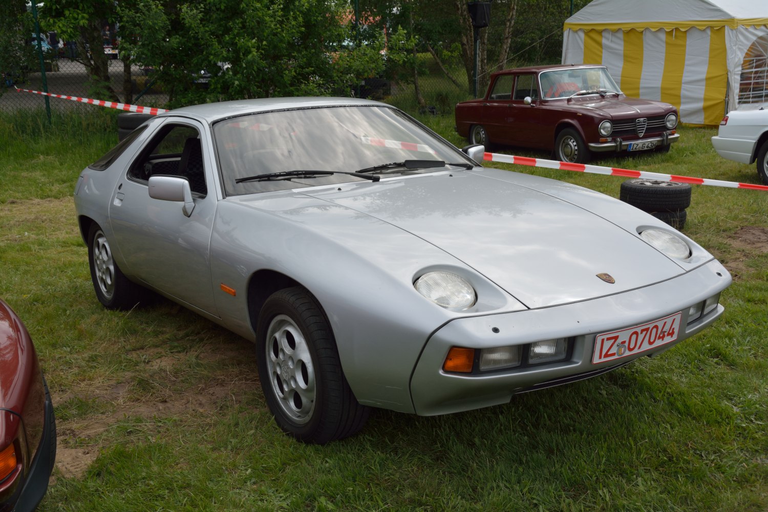 Silver sports coupe with pop-up headlights and sleek front angle