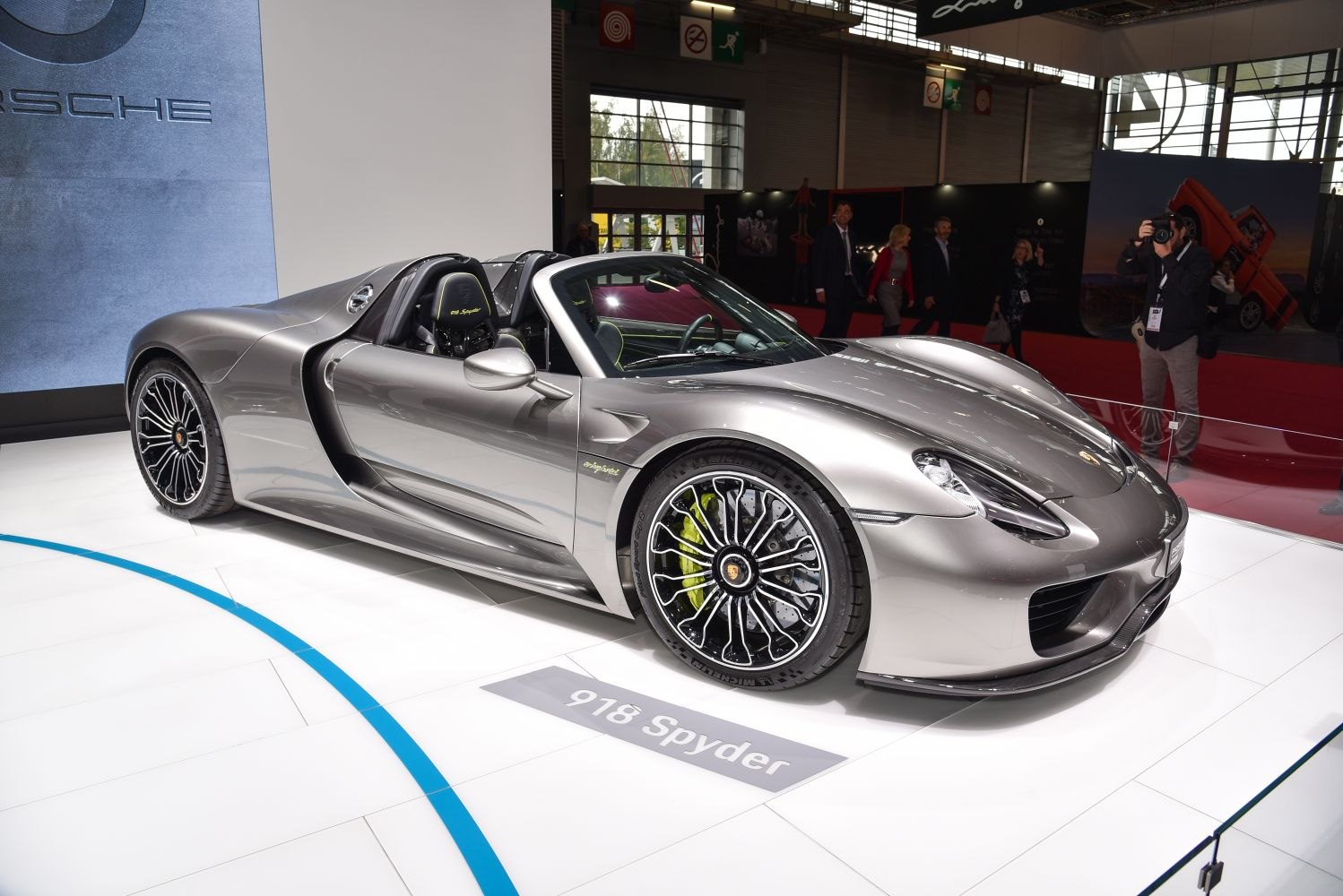 Convertible hybrid sports car with aerodynamic design and intricate wheel rims