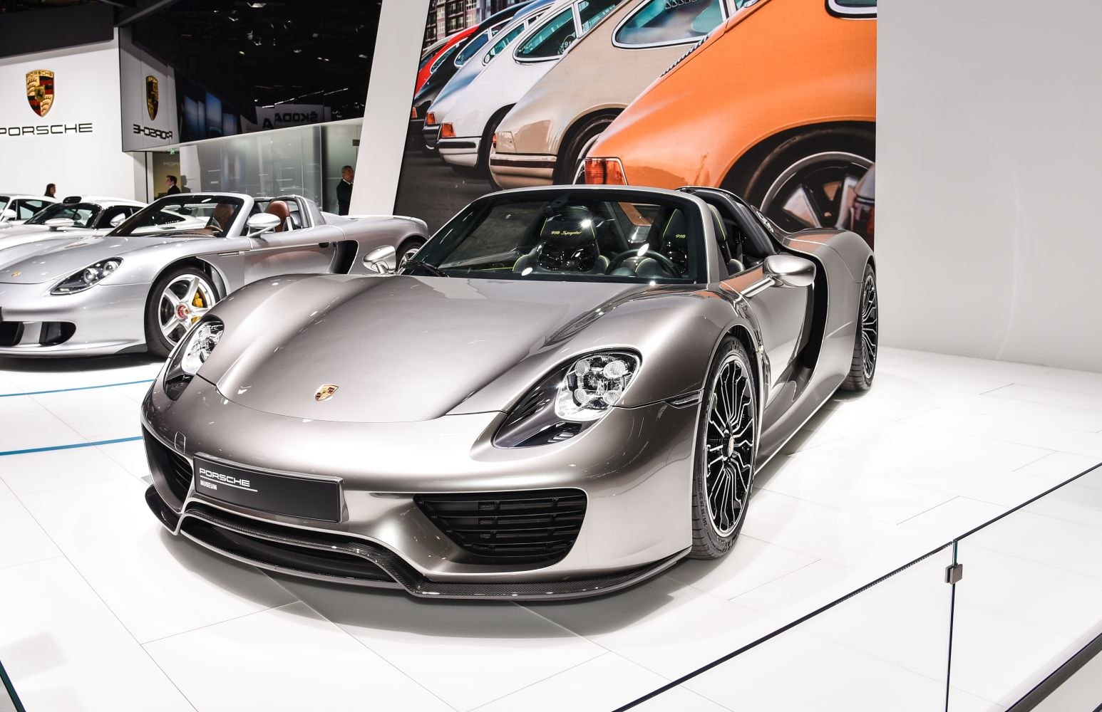 Silver hybrid sports car with aerodynamic body and advanced headlights