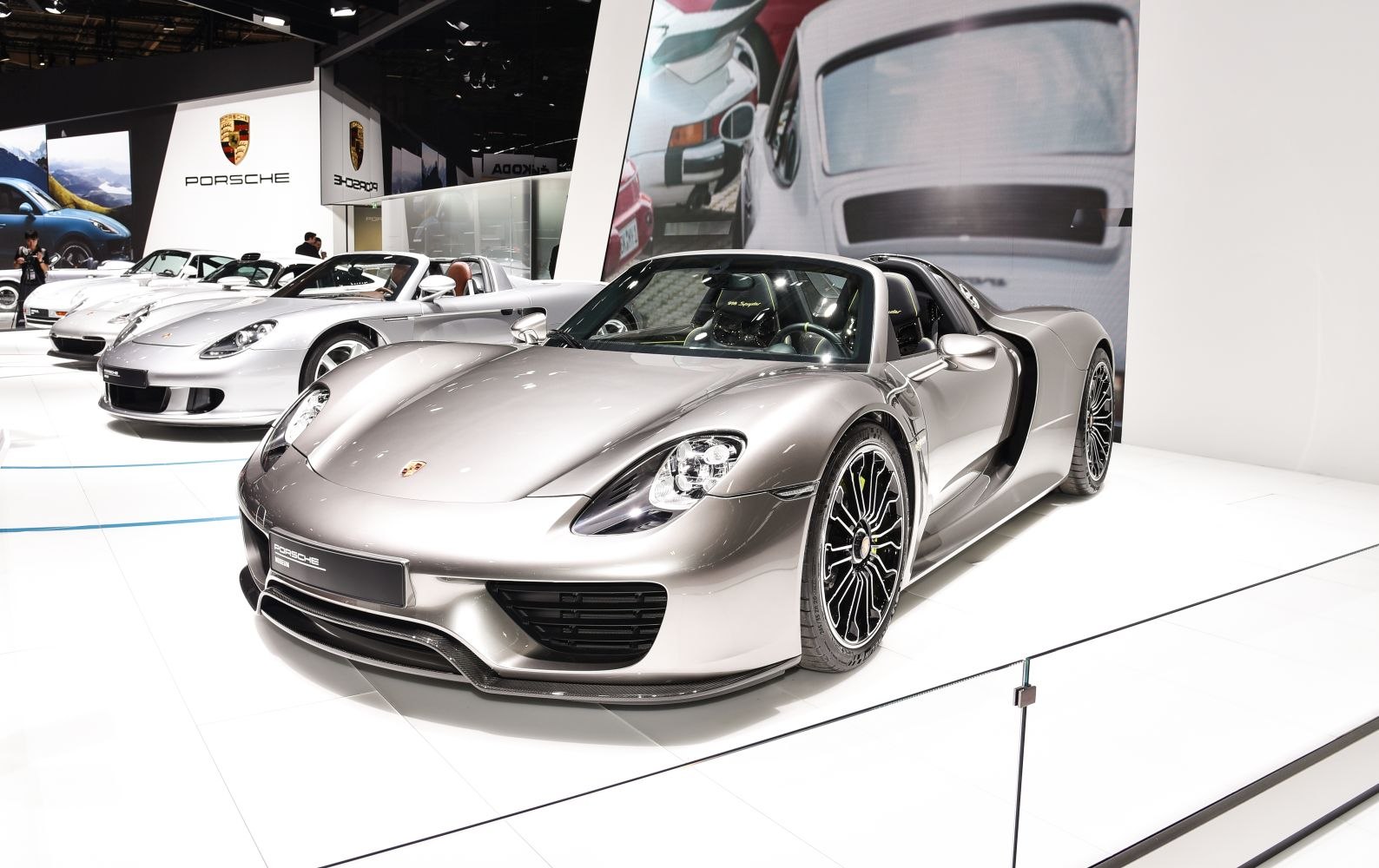 Silver convertible sports car front with aerodynamic design and stylish wheels