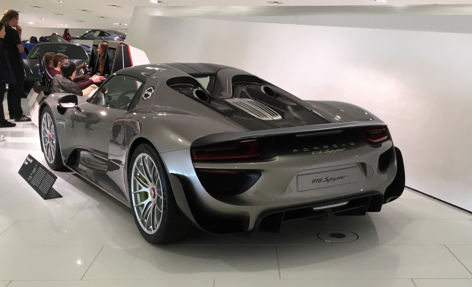 Rear view of a hybrid supercar with aerodynamic design and twin exhausts