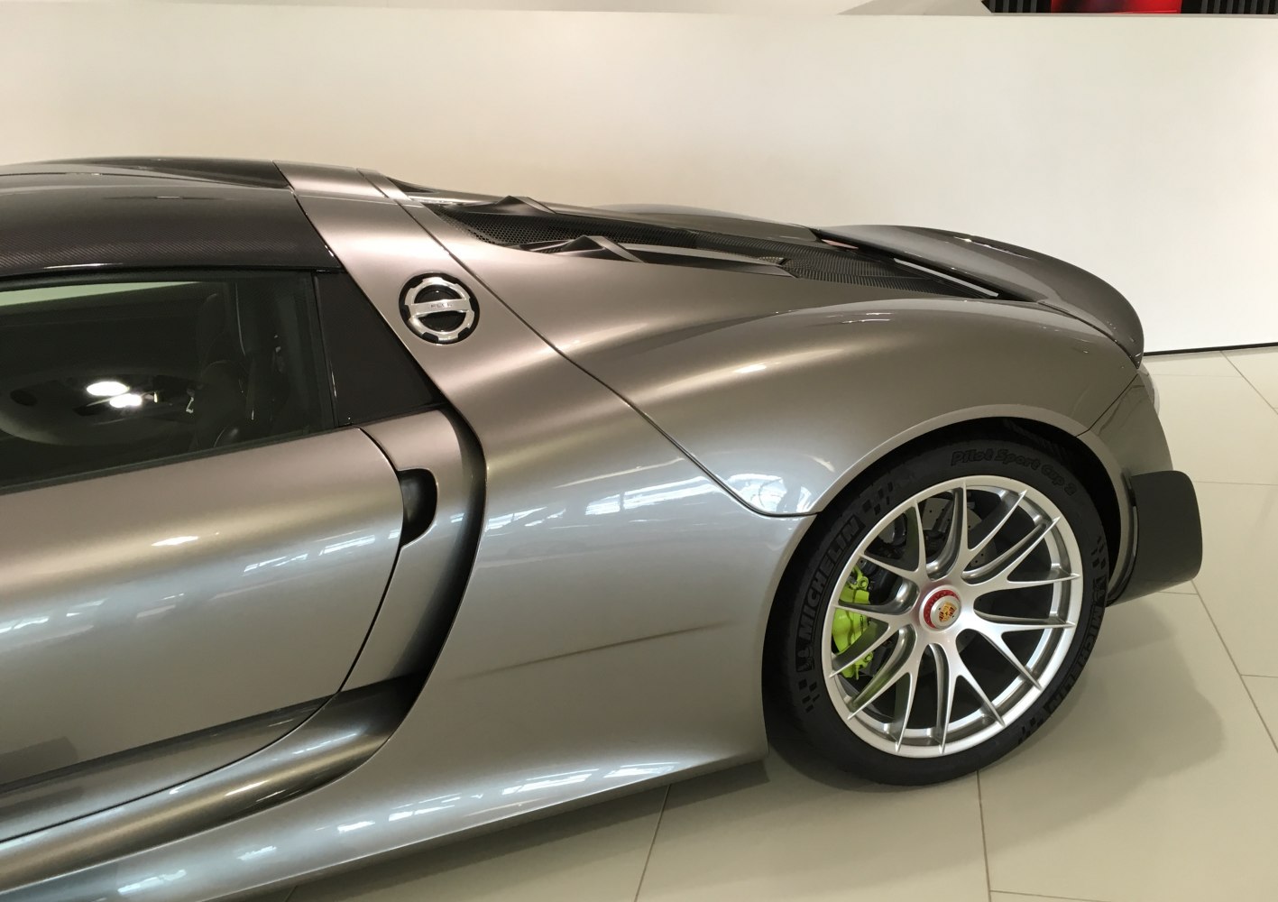 Rear side with aerodynamic air intake, carbon roof, and detailed alloy wheel