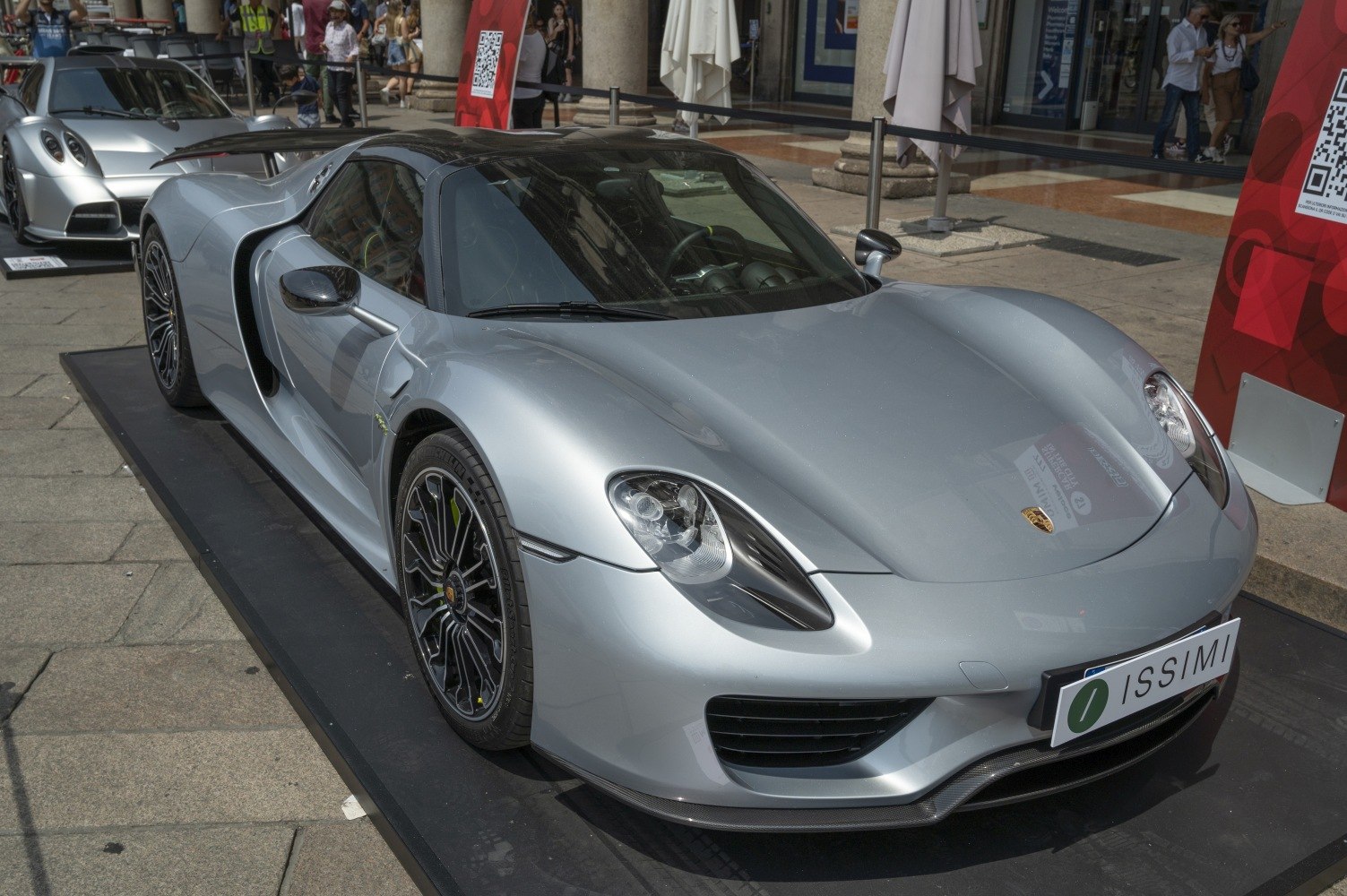 Front side view of aerodynamic hybrid sports car with distinctive LED headlights and detailed wheel design