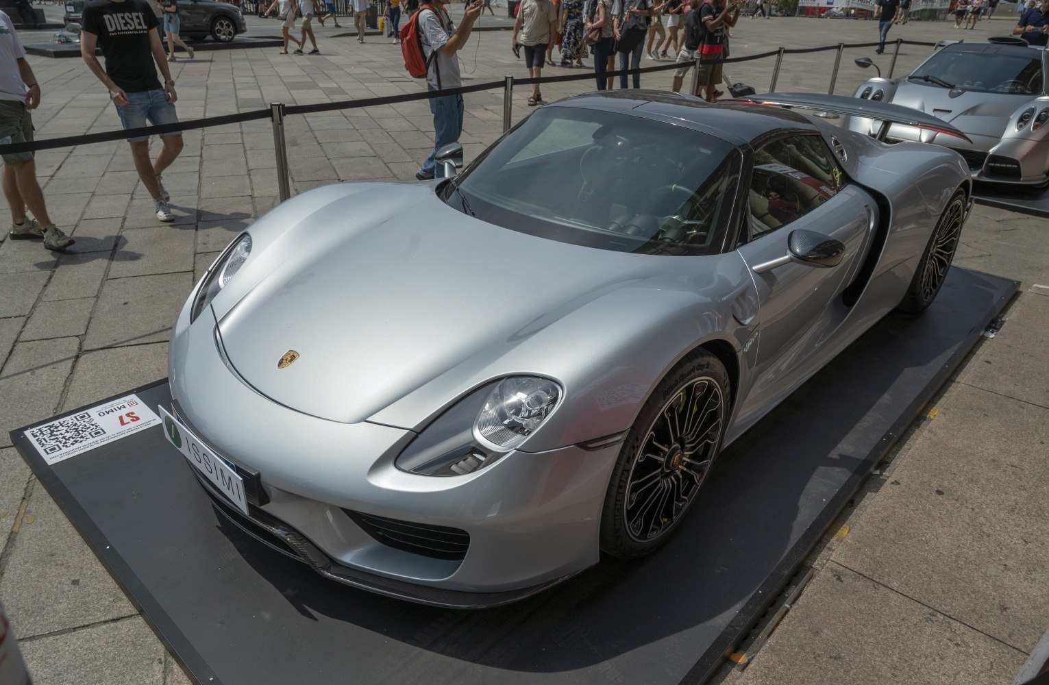 Silver hybrid supercar with aerodynamic body and unique wheels