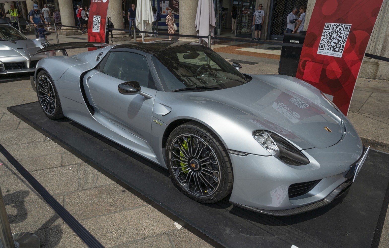 Silver hybrid sports car with aerodynamic design and black multi-spoke wheels