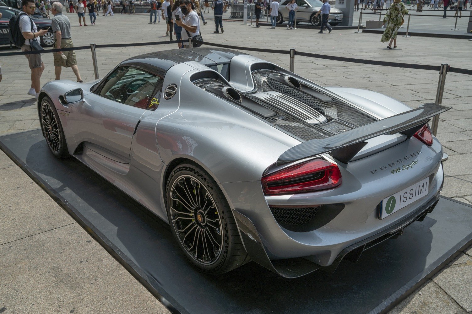 Sleek sports car rear with aerodynamic wing and exposed engine vents