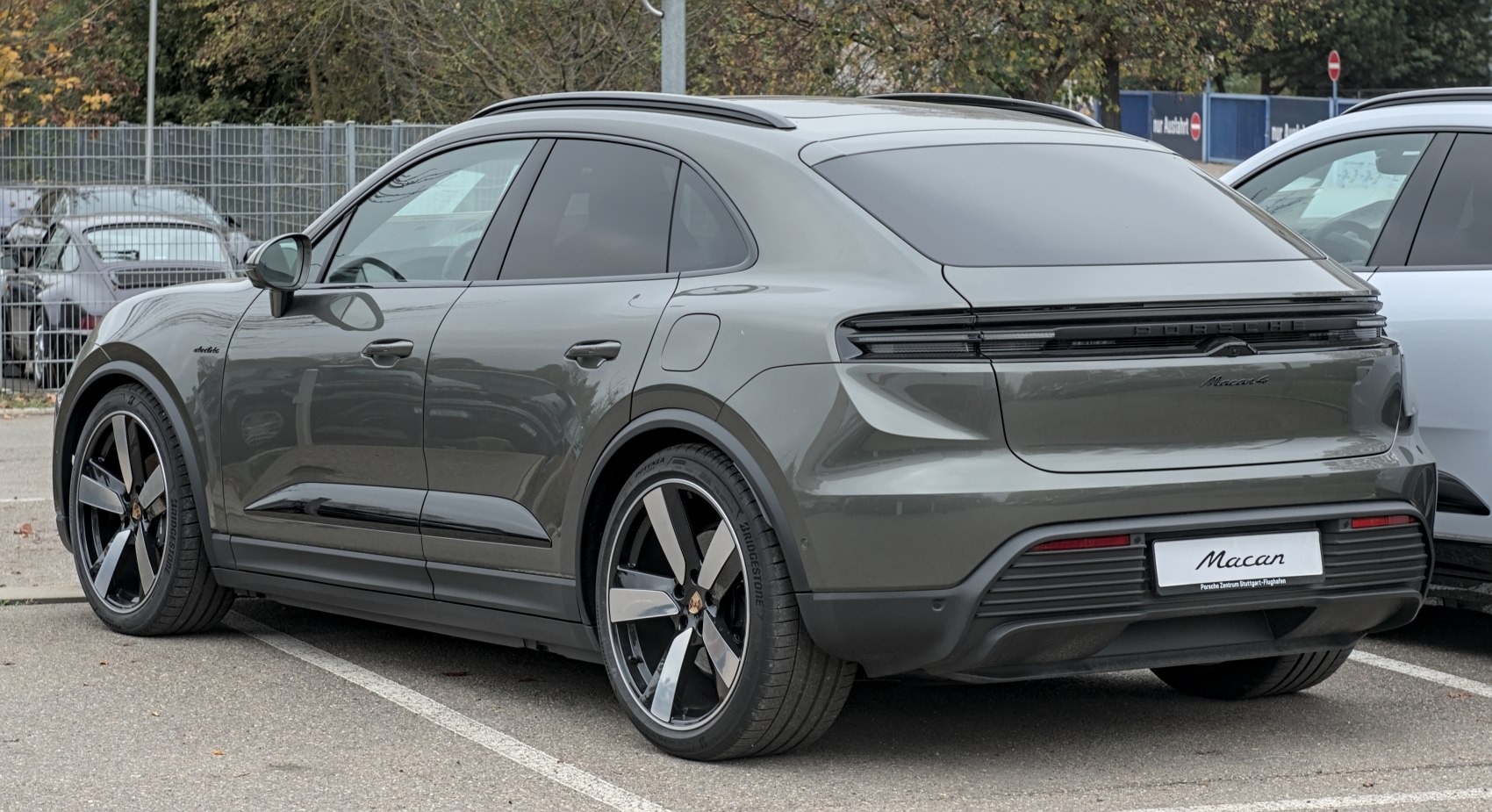 Rear-side view of sleek electric SUV with continuous taillight and modern styling