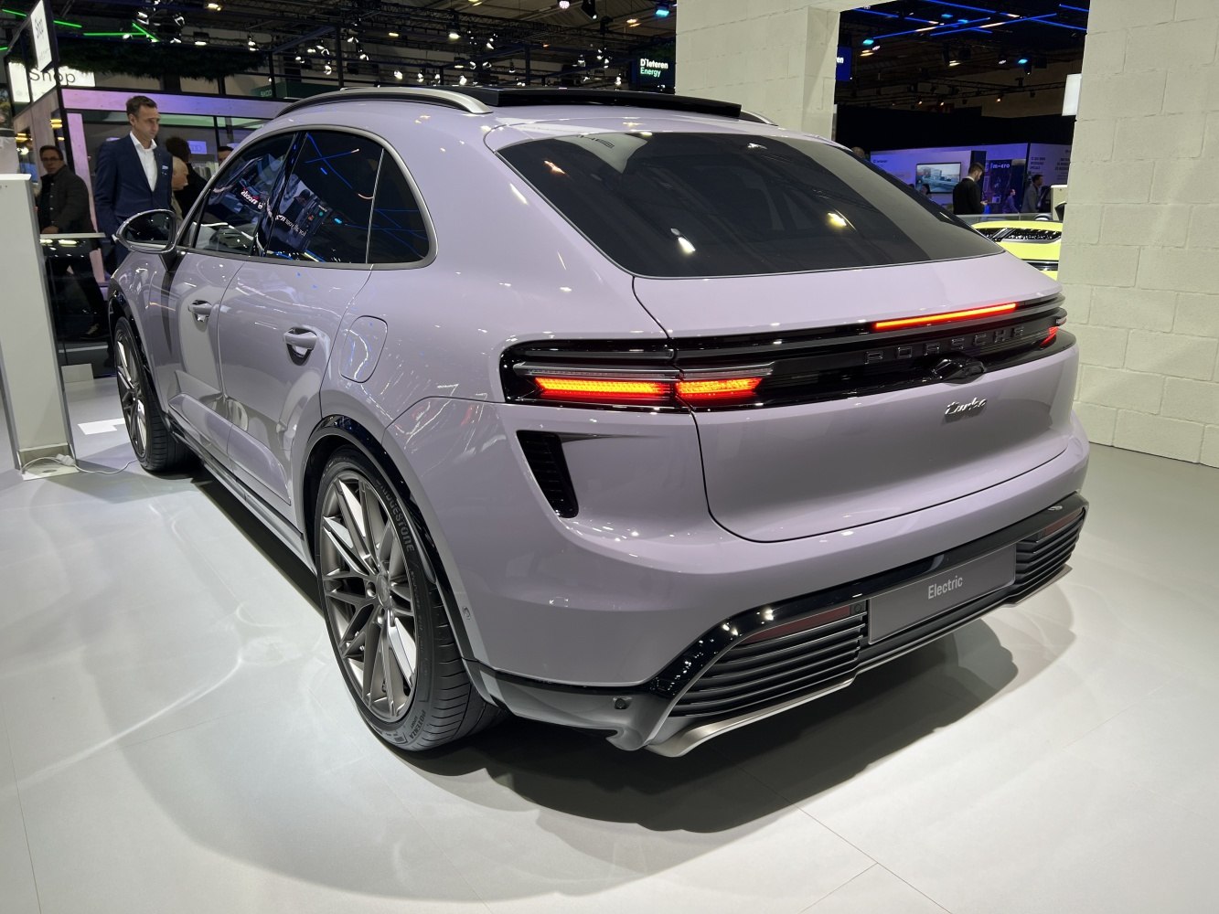 Sleek rear design with illuminated tail lights and large wheels.