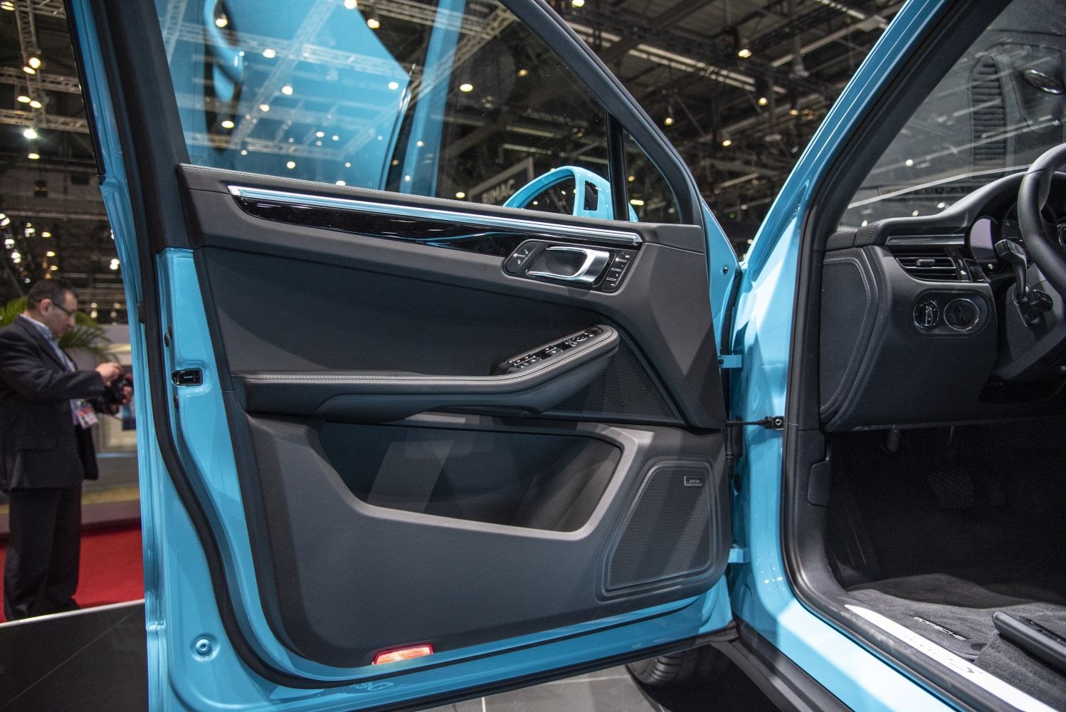 Luxury car interior door panel with controls and speaker
