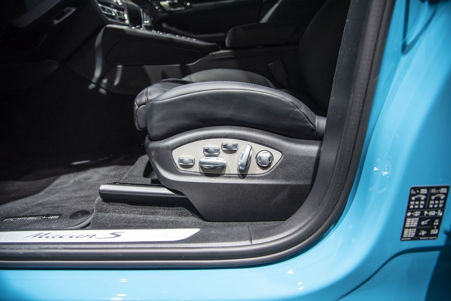Electric seat adjustment controls on black leather seat