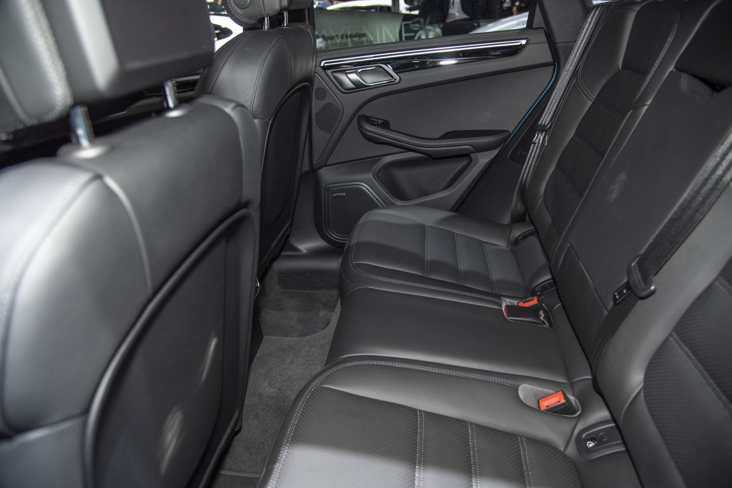 Black leather rear car seats with door panel and seat belts
