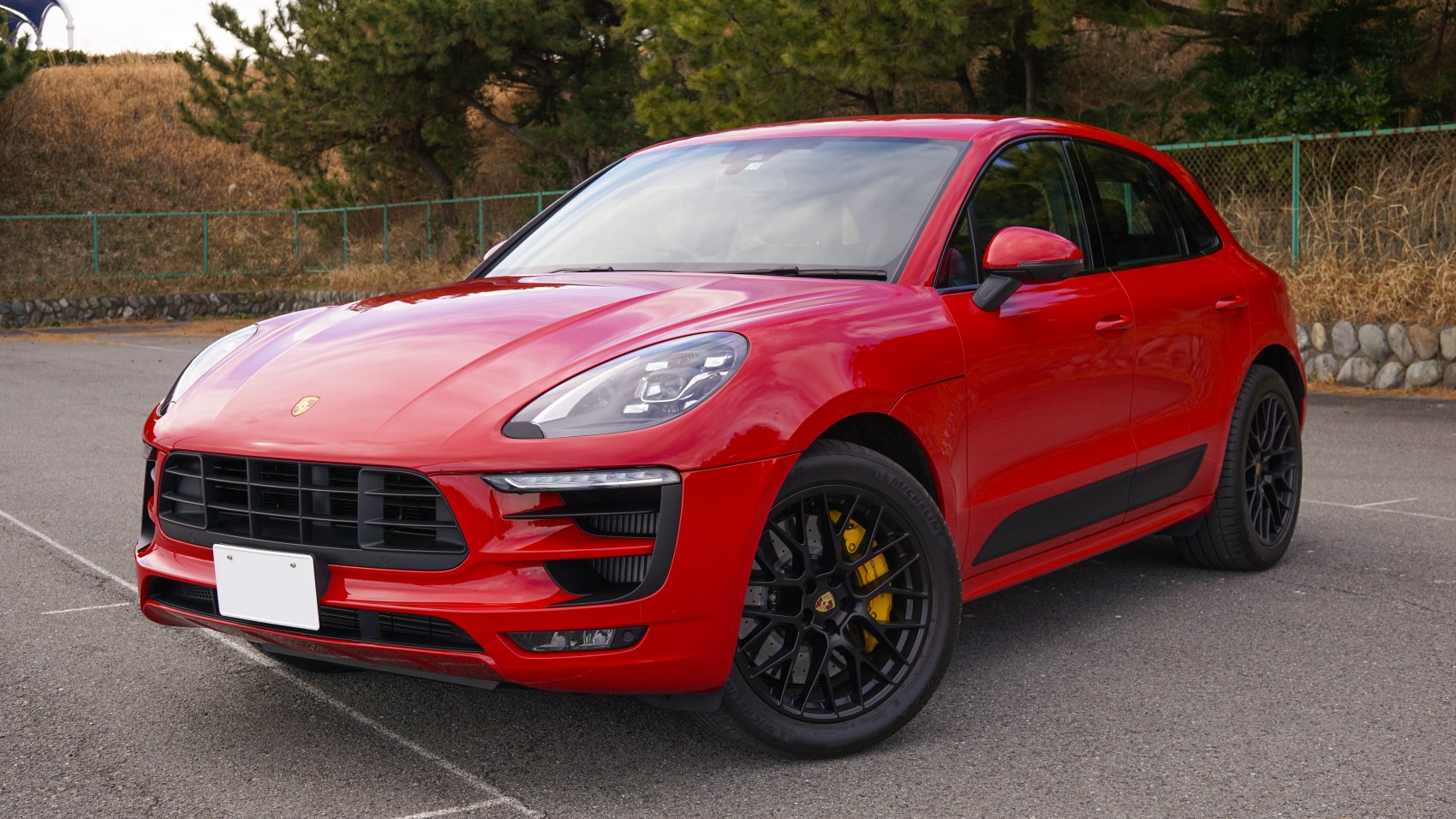Red SUV with black alloy wheels and yellow brake calipers