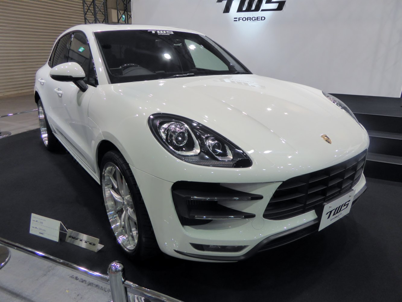 White SUV front with distinctive headlights and aggressive grille