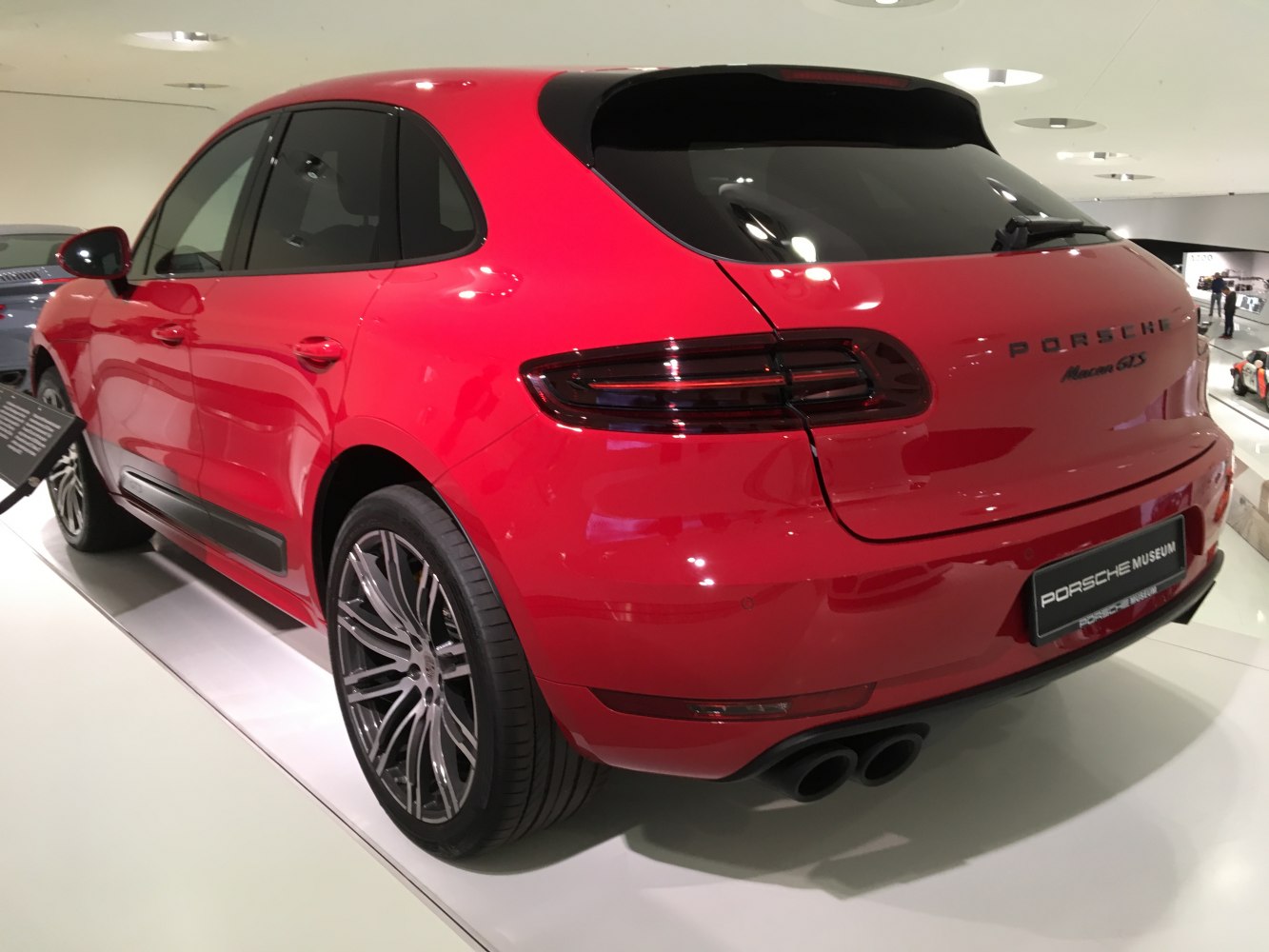 Red SUV rear and side view with blacked-out taillights and multi-spoke alloy wheels