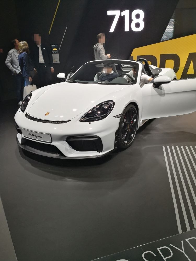 White convertible sports car with open roof and sleek front design